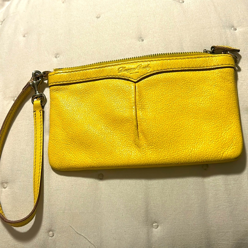 Dooney & Bourke wristlet in good condition in yellow a little fading